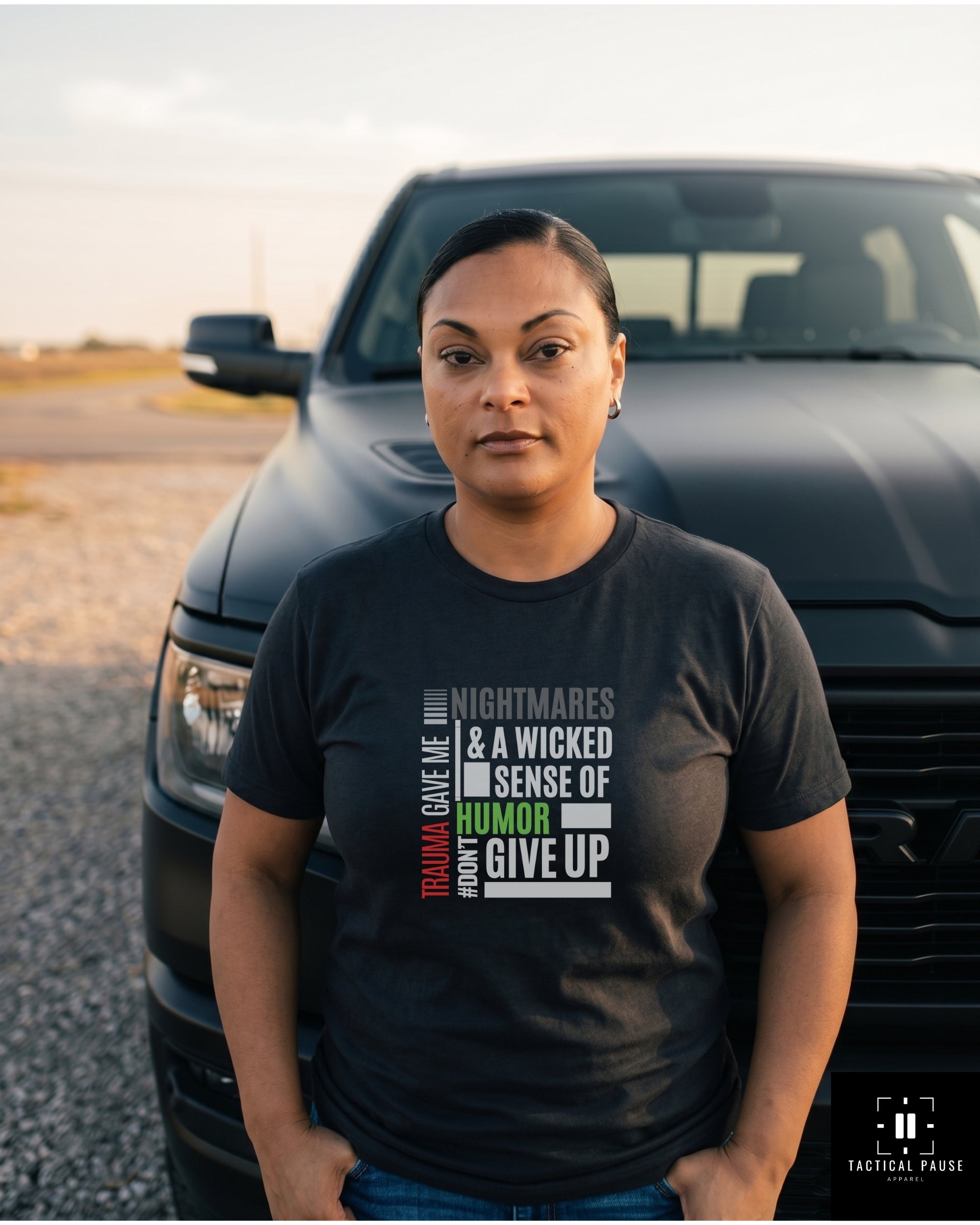 Veteran in black Trauma & Humor Resiliency tee standing by a truck, off-duty outdoor lifestyle — Tactical Pause Apparel