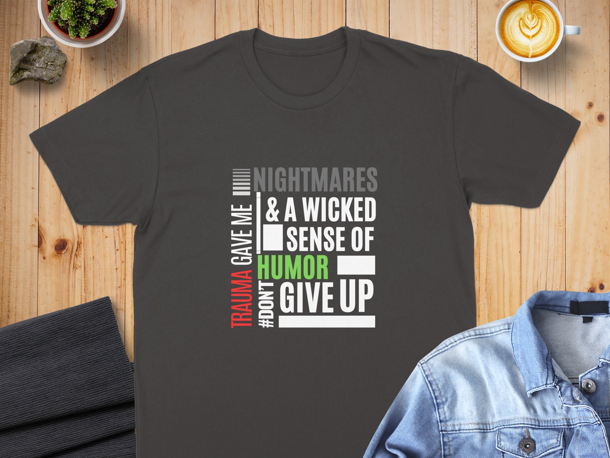 Dark grey t-shirt with "TRAUMA GAVE ME #DONT GIVE UP NIGHTMARES & A WICKED SENSE OF HUMOR" text.