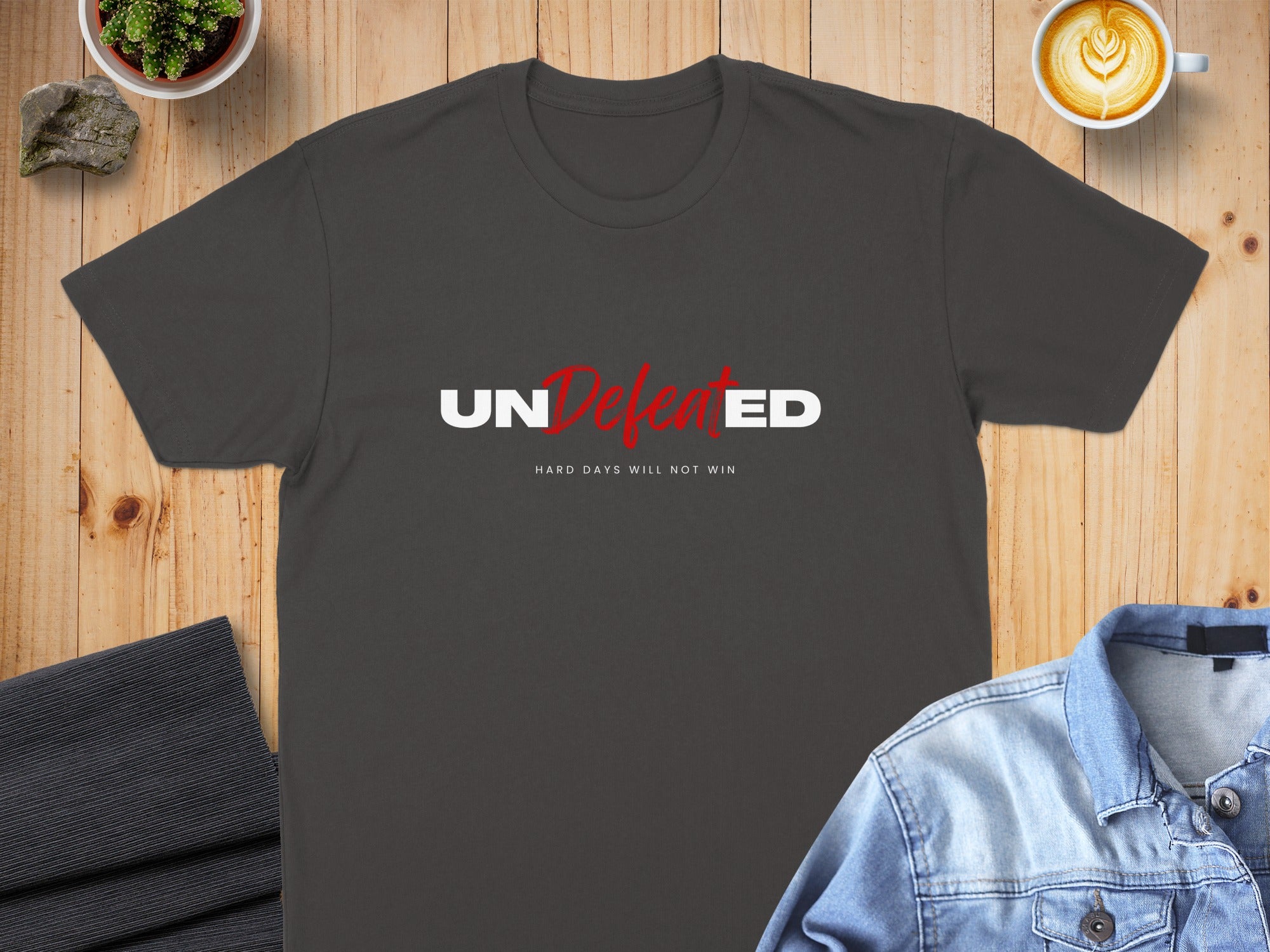 Dark gray t-shirt with "UNDEFEATED" and "HARD DAYS WILL NOT WIN" text.