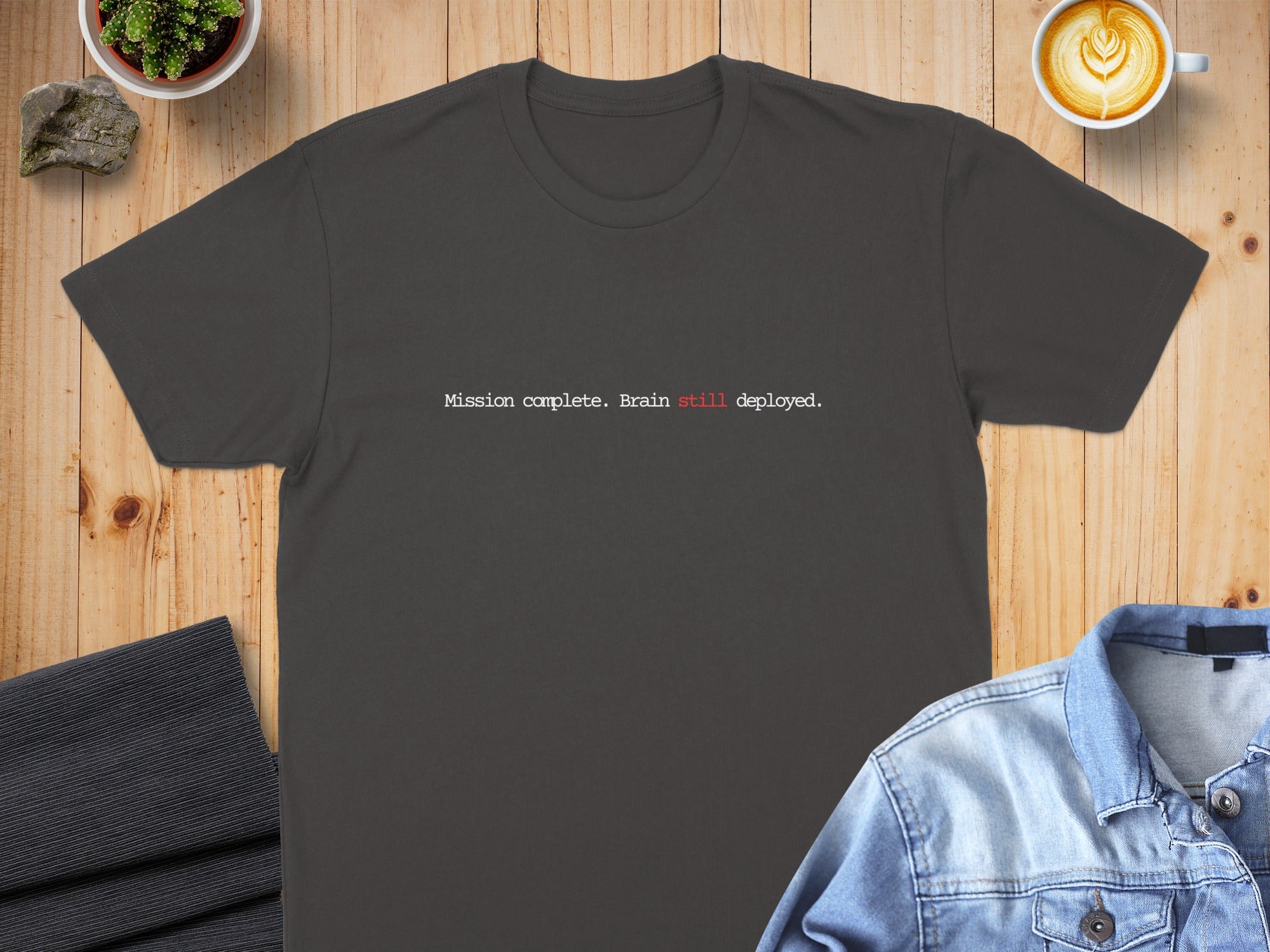 Dark gray t-shirt with "Mission complete. Brain still deployed." text.