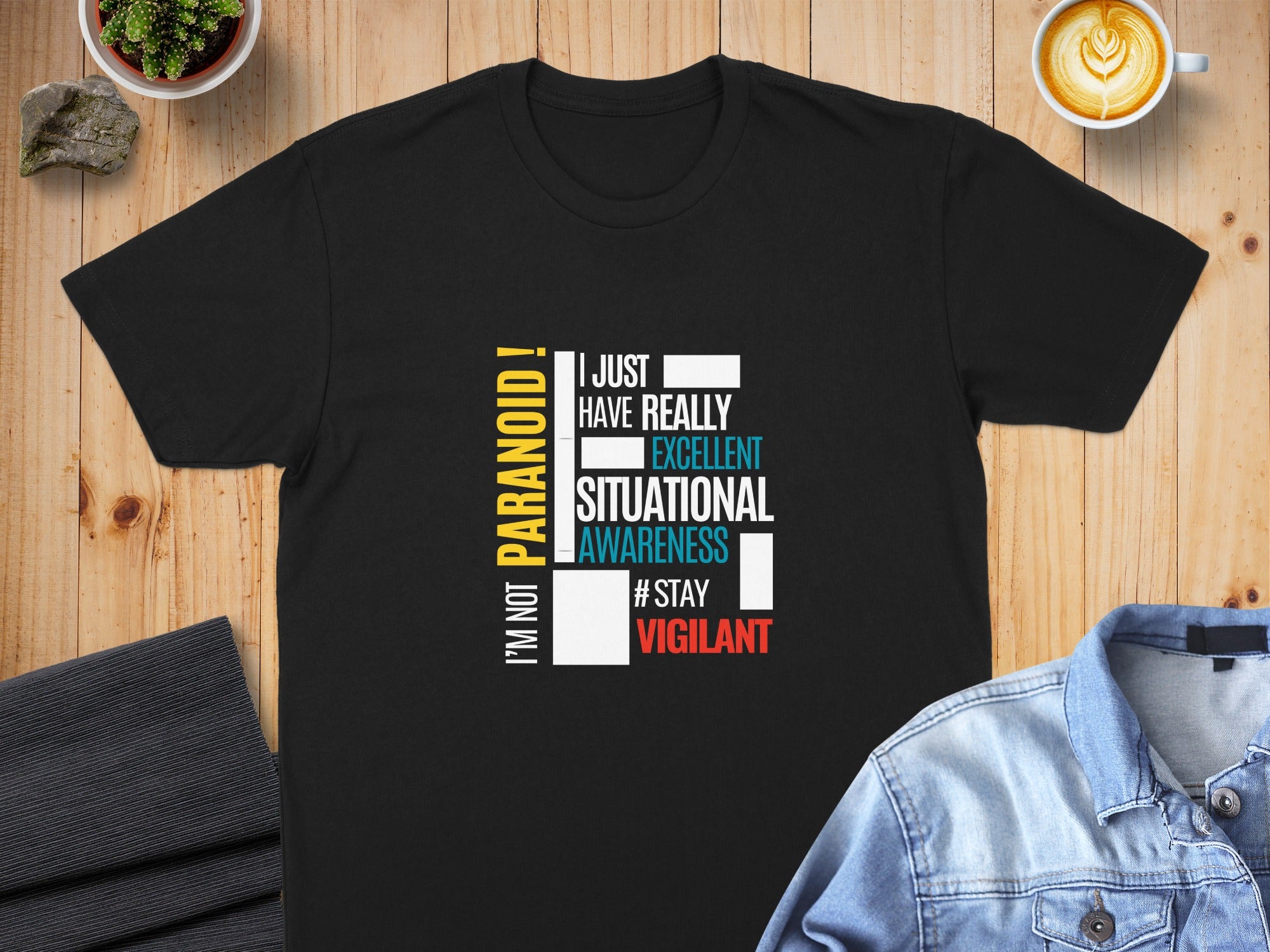Black t-shirt with white and yellow text: "I'M NOT PARANOID! I JUST HAVE REALLY EXCELLENT SITUATIONAL AWARENESS #STAY VIGILANT."