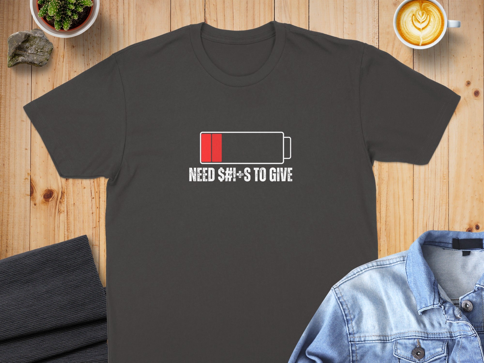 Dark t-shirt with "S#!+S TO GIVE" and a low battery icon.