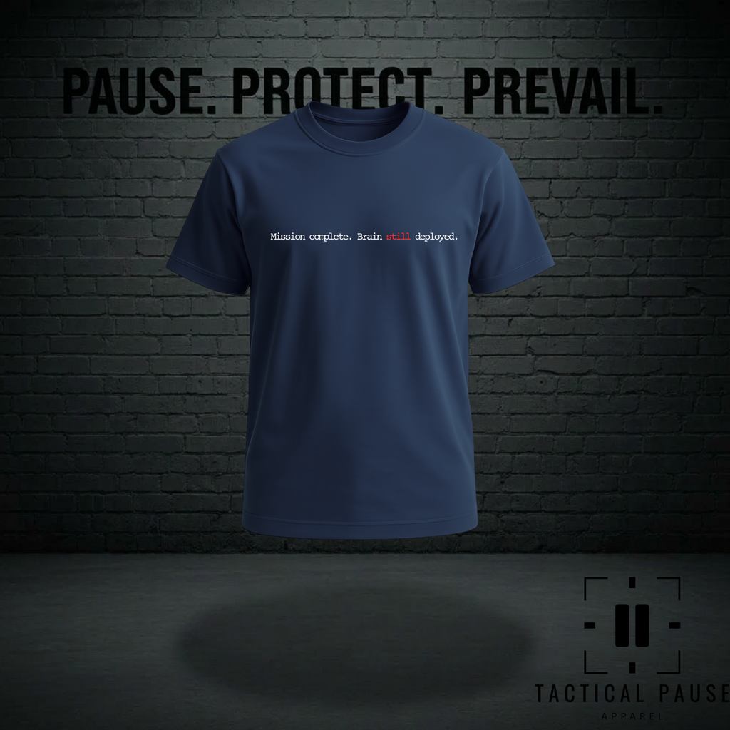 Blue t-shirt with text on a dark brick wall background. The design on the shirt is Mission complete, brain still deployed.