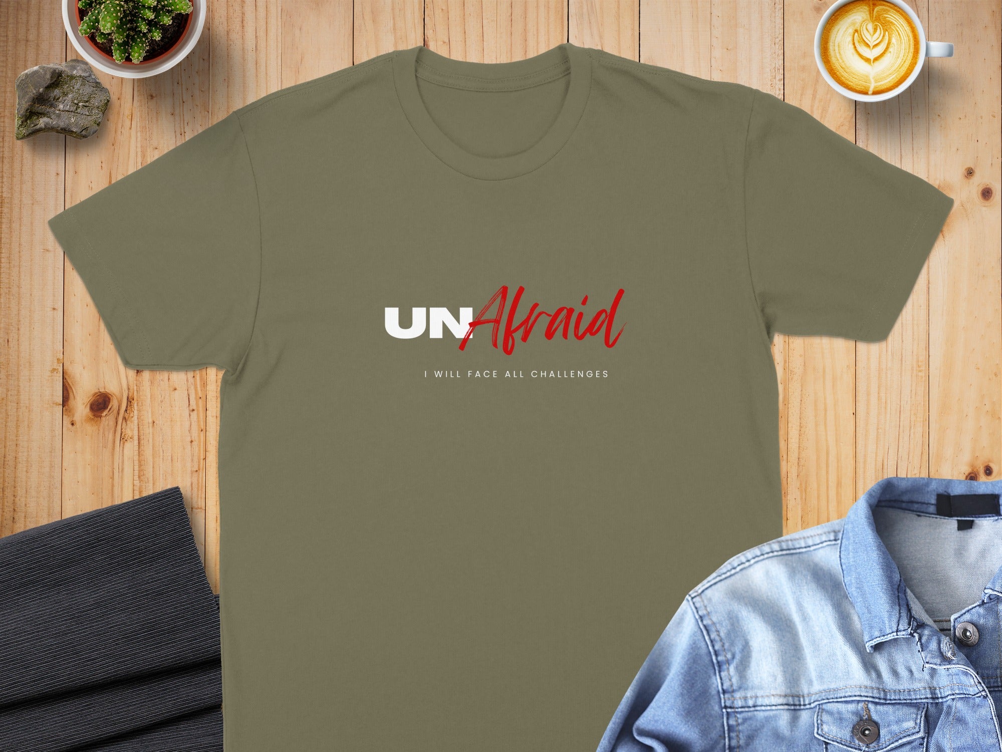 Olive green t-shirt with "UNAfraid" and "I WILL FACE ALL CHALLENGES" text.