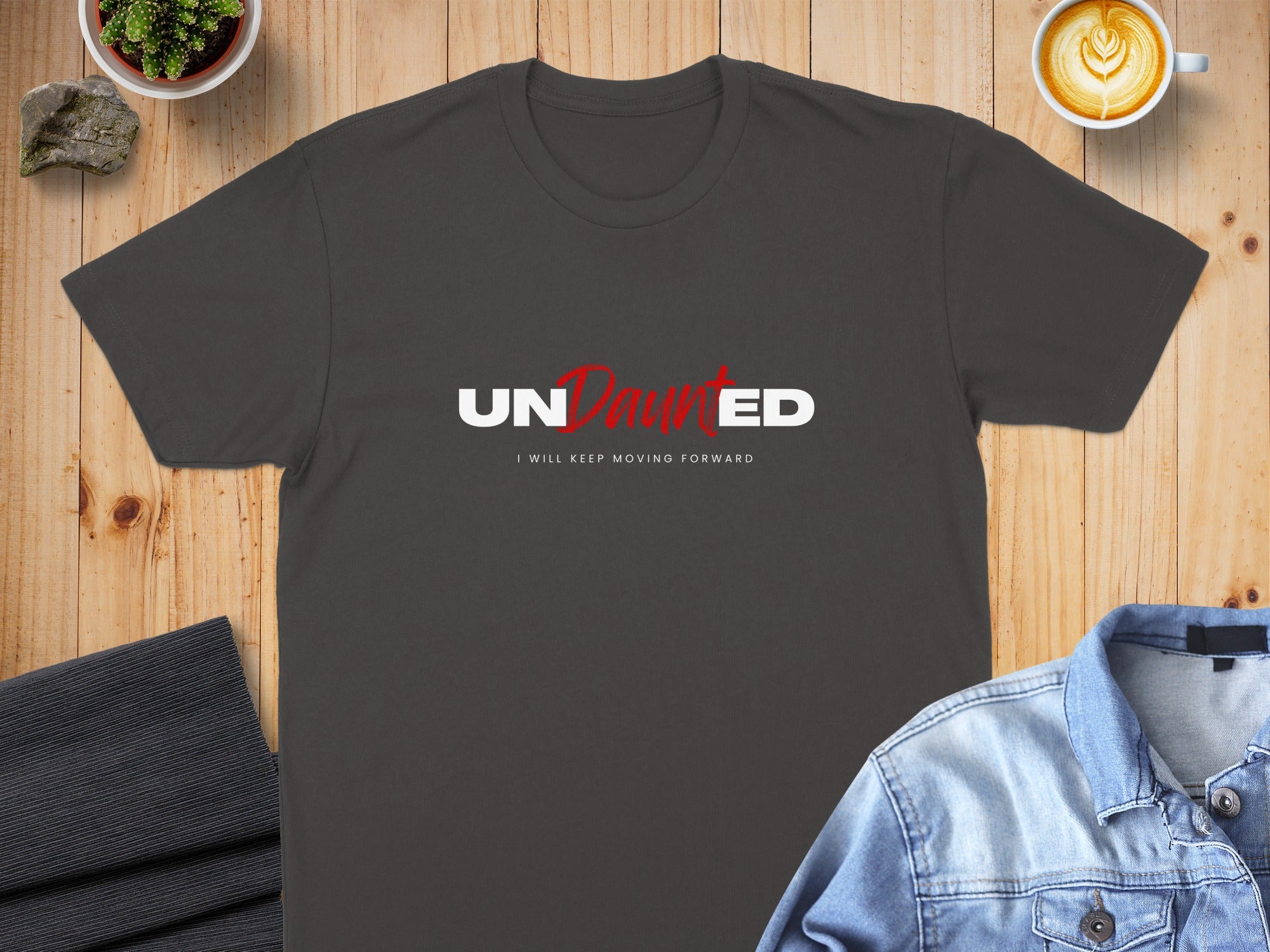 Dark grey t-shirt with "UNDAUNTED" and "I WILL KEEP MOVING FORWARD" text.